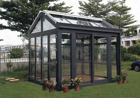 Aluminum greenhouse with a glass side door, providing a bright and accessible space for gardening enthusiasts.
