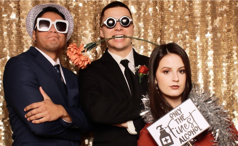 A couple poses with another man and woman for a fun photo at a Houston Boomerang booth rental.