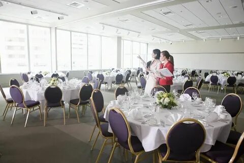 A well-organized banquet hall with tables and chairs, designed for weddings, by Trusted Planners for NJ Weddings.